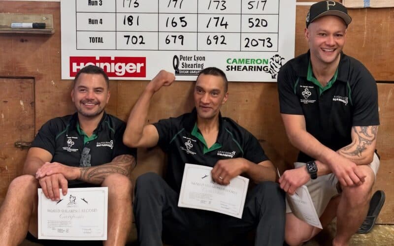 Shane Ratima with teammates Leon Samuels and Paerata Abraham beside the 2073 tally board and their record certificates